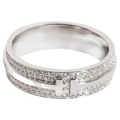 Tiffany & Co. T Wide Pave Diamond Ring in 18K White Gold 0.63 Ctw PRIMARY DETAILS SKU: 121836 Listing Title: Tiffany & Co. T Wide Pave Diamond Ring in 18K White Gold 0.63 Ctw Condition Description: Retails for 8000 USD. In excellent condition and recently polished. Ring size is 8.Comes with Box;Appraisal; Brand: Tiffany & Co. Collection/Series: Tiffany T Metal Type: White Gold Metal Purity: 18k Ring Size: 8 SIDE STONE INFORMATION Side Stone 1 Gem Type: Diamond Side Stone Weight 1 (cts): 0.63 Sid Tiffany And Co Mens Ring, Wedding Ring Men Tiffany, Tiffany Couple Ring Wedding Bands, Tiffany Diamond Ring, Tiffany Wedding Rings, Tiffany Co Rings, Alexa Demie, Tiffany T, Pave Diamond Ring