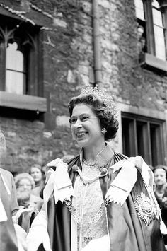 black and white photograph of two women in gowns talking to each other on the street