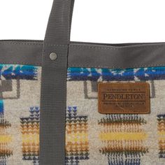 The Pendleton Zip Tote is the perfect accessory for the modern, confident woman! Made from USA-made wool and trimmed in supple leather, this bold, Chief Joseph Blue patterned handbag is sure to add style and sophistication to any outfit. Make a statement in luxury and quality with this tote! Body: 100% Virgin Wool; Contrast: 100% Polyester; Linging: 100% Polyester; Trim: 100% Cowhide leather Imported 14" x 6" x 12.5" Spot Clean Imported of USA fabric Zip closure Rectangular Wool Shoulder Bag For Travel, Wool Rectangular Shoulder Bag For Travel, Wool Travel Bags For Fall, Chief Joseph, Handbag Patterns, Zip Tote, Confident Woman, Cowhide Leather, The Modern