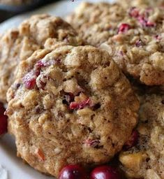 cookies with cranberries are stacked on a plate