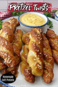 some pretzel twists are on a plate with dipping sauce