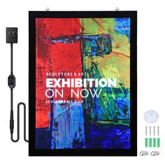 an art exhibition on now poster is displayed with markers, pens, and inks