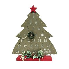 a wooden christmas tree clock with numbers on it