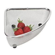 three strawberries in a strainer on a white background