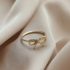 Ⓜ 14K Gold Bow Infinity Ring The bow ring in its minimal desing with the infinity symbol symbolizing innocence is one of the most beautiful gift options you can buy for yourself or your loved ones ⓂMaterials & Specifications : 14K Gold Bow Ring Ring Width : 7,21 mm (0.28 in) Ring Length : 13,61 mm (0.53 in) 3 Colours are in options. Check out our return policy for personalized products. Personalized order group All rings made to be custom made. Ring Aesthetic Minimalist, Bow Gold Ring, Cute Ring Designs, Ins And Outs List, Bow Ring Gold, Gold Rings Dainty, Cute Jewelry Aesthetic, Coquette Rings, Cute Simple Rings