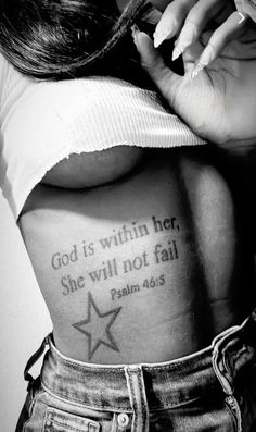 the back of a woman's body with a tattoo saying god is within her, she will not fail