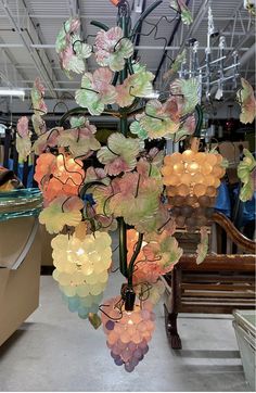 a chandelier hanging from the ceiling in a store filled with lots of lights