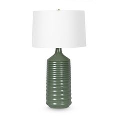 a green lamp with a white shade on the base and a light that is attached to it