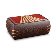 a wooden box with an intricate design on the lid and sides, made out of wood