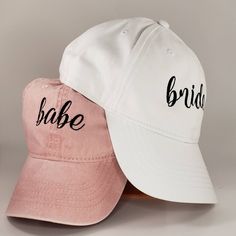 two hats with the word bride and bridal written on them are sitting side by side