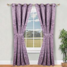 a window with purple curtains and a potted plant