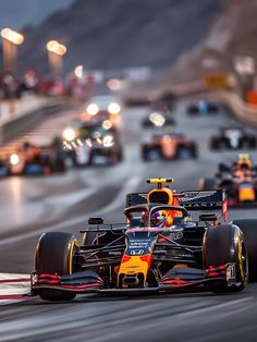 the red bull racing car is driving in front of other cars on a race track