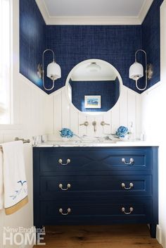 a bathroom with blue cabinets and white walls