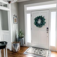 a white door with a wreath on it