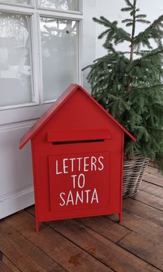 a red mailbox with letters to santa written on it