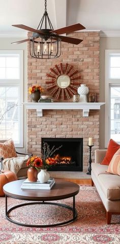 a living room filled with furniture and a fire place in front of a brick wall