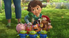 an animated character is standing in the grass with many toy animals and people behind him