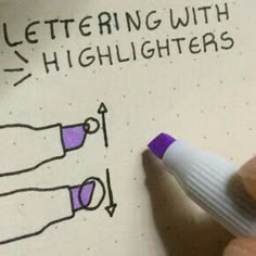 a hand holding a marker next to a piece of paper that says lettering with highlighters