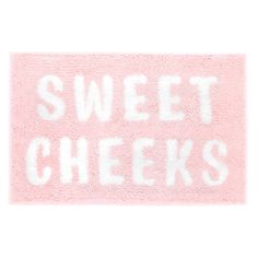 a pink rug with the words sweet cheeks written on it in white ink, against a white background