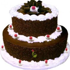 three layered chocolate cake with white frosting and cherries