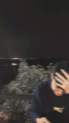 a blurry image of a person covering their face