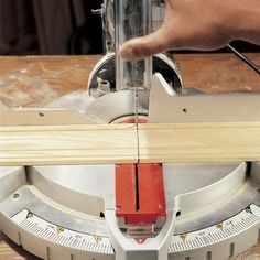 a person using a circular saw to cut wood