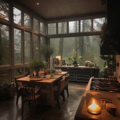 a kitchen filled with lots of windows next to a stove top oven and counter top