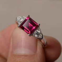 This is a gorgeous handmade creation. Its beauty is its simplicity & Elegance. The 7*7 mm square shape faceted lab ruby is crafted in solid sterling silver and with rhodium plated. All item is sent in a beautiful gift box If you have any idea of design your ring,pls contact me directly. You can realize more lovely stuff clicking the link https://www.etsy.com/shop/knightjewelry?refshopsection_shophome_leftnav Please leave the correct address and you phone number for delivering successfully. Red Gemstone Ring, July Birthstone Ring, Ruby Engagement Ring, Birthday Ring, Red Gemstones, July Birthstone, Anniversary Gift For Her, Diamond Solitaire Engagement Ring, Ruby Ring