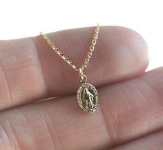 A delicate and dainty statement Virgin Mary oval charm necklace in sterling silver, gold filled and vermeil or 14k or 18k solid gold perfect for everyday wear. A tiny Blessed Mother of Jesus religious necklace. This minimalist Christian religion symbol necklace is a perfect baptism or birthday gift for any religious person.
Please select the material and chain length from the drop-down menu on the right side of the listing. If you have any questions, please send us a message.
Birthstones can be Baptism Necklace, Miraculous Medal Necklace, Jesus Necklace, Mary Necklace, Gold Body Chain, Virgin Mary Necklace, Gold Bodies, Symbol Necklace, Buy Necklace