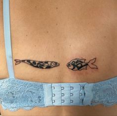 two fish on the back of a woman's stomach