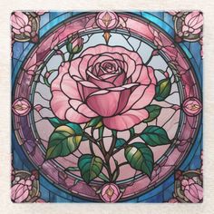 a stained glass window with a pink rose in the center and green leaves on it