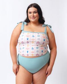 Say hello to your new favorite swim crop! Longer than a bra, shorter than a tankini, this crop has Azul ties and band at the top of our cute, custom Shell Stripe print. Built-in shelf bra for great support. Pair with matching bottoms for a set, or mix it with your favorite solid or print! Available in XXS-4XDouble lined shelf bra with foam cups82% nylon, 18% spandexFull front polyester liningProvides UV 50+ protectionResponsibly made in Mexico A portion of proceeds from this suit goes to bringin Crop Swim Top, Short One Piece, Bandeau Crop Top, Swim Skirt, High Waist Bottoms, Timor Leste, Built In Shelves, Swim Dress, Shelf Bra