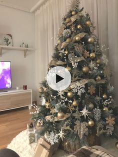 a living room with a christmas tree in the corner and a tv on behind it