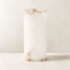 a marble vase sitting on top of a white table