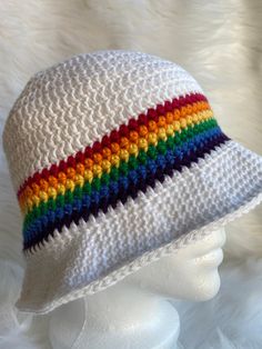 It's summertime and that means time for a nice cool bucket hat. This white hat features a bright rainbow stripe - red, orange, yellow, green, blue and purple- between the hat body and the brim. A very striking bucket hat made with 100% cotton yarn that will ensure your comfort in the warm weather and protect your head from the suns hot rays. Retro Multicolor Bucket Hat For Summer, Colorful Summer Bucket Hat With Curved Brim, Retro Multicolor Sun Hat For Summer, Retro Multicolor Summer Hats, Retro Multicolor Summer Sun Hat, Adjustable Rainbow Hats For Summer, Colorful Casual Bucket Sun Hat, Colorful Casual Bucket Hat, Casual Colorful Bucket Sun Hat