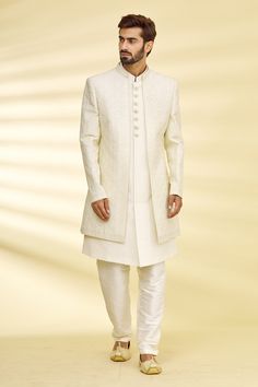 Cream full sleeve jacket with floral embroidered motifs. Paired with sherwani and pant.
Component: 3
Pattern: Embroidered
Type Of Work: Floral
Neckline: Mandarin
Sleeve Type: Full Sleeves
Fabric: Silk, Dupion Silk
Color: Beige
Other Details: 
Front buttons
Note: The fabric is silk blend and not pure silk
Occasion: Wedding - Aza Fashions Men's Indowestern, Gents Clothes, White Sherwani, Indian Wedding Suits Men, Men Sherwani, Indian Wedding Clothes For Men, Sherwani For Men Wedding, Embroidered Sherwani, Wedding Kurta For Men