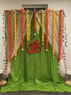 an altar decorated with orange and green garlands