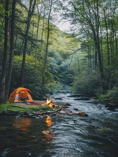 a tent pitched up next to a river in the woods with a campfire on the bank