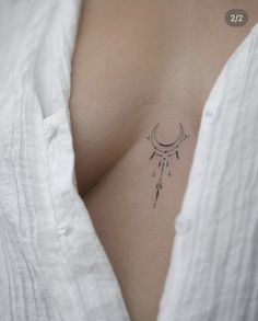 a woman's chest with a small tattoo on the left side of her stomach