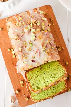 a loaf of bread with frosting and nuts on top