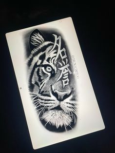 a tiger tattoo is shown on the back of a hand held up to show it's face