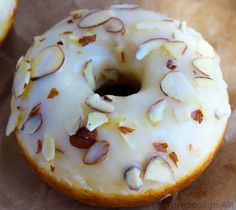 two glazed donuts with white frosting and nuts