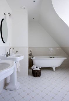 a bathroom with two sinks and a bathtub