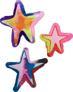 three star shaped magnets on a white background