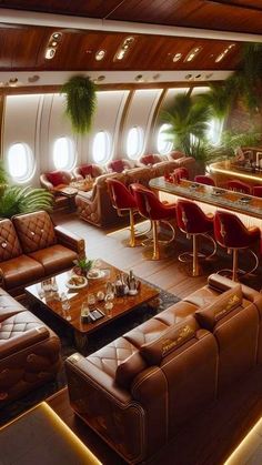 the interior of an airplane with leather couches and tables