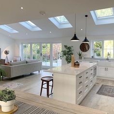 an open kitchen and living room with skylights