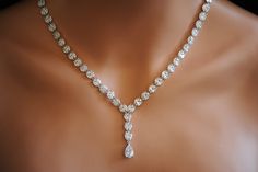 a diamond necklace is displayed on a mannequin's neckline in this image