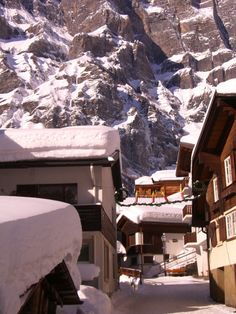 snow covered buildings and mountains in the distance