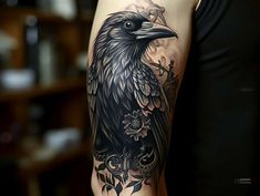 a woman with a black and grey tattoo on her arm, wearing a crow design