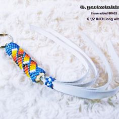 a white lanyard with multicolored beads on it